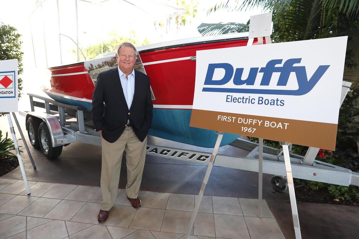 Duffy Duffield stands next to his first "Duffy" electric boat during the Newport Harbor Foundation kickoff Oct. 14.