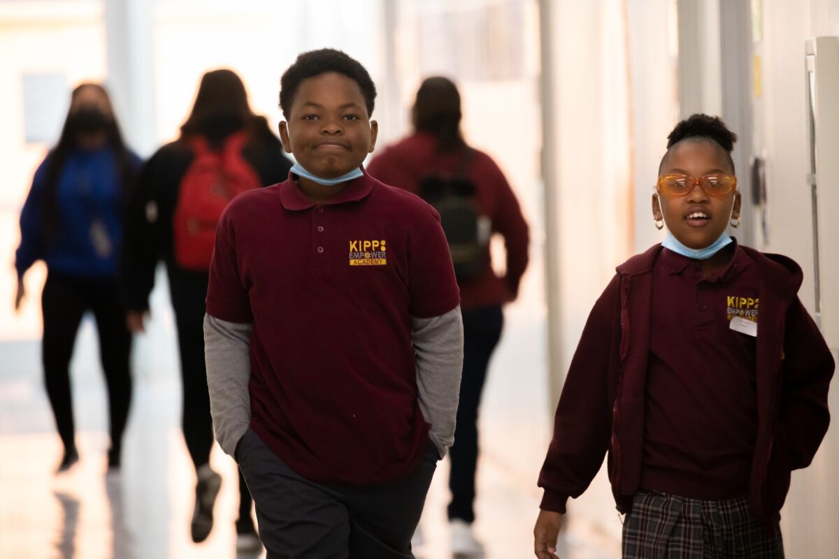 Two fourth-graders stand in a hallway at KIPP Empower Academy.