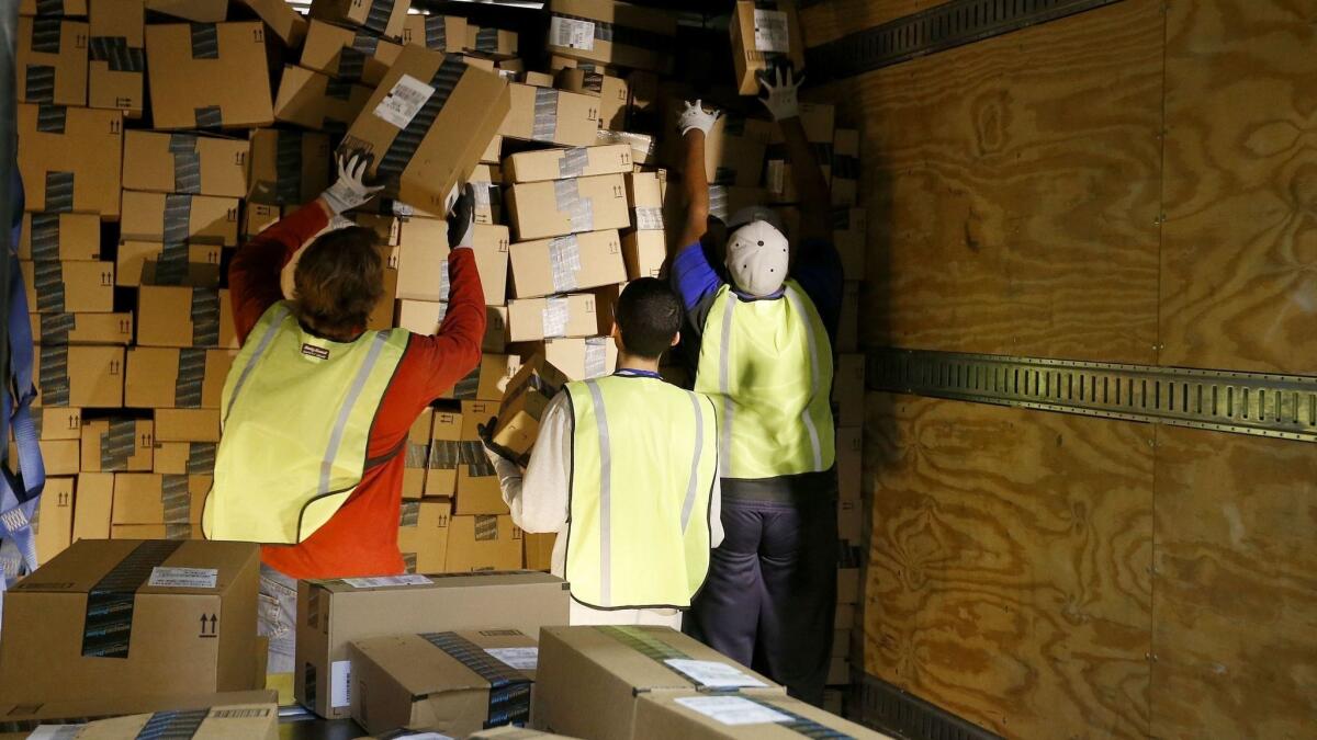 Amazon.com employees pack up an outbound shipping truck at a Phoenix fulfillment center on Cyber Monday in 2013.