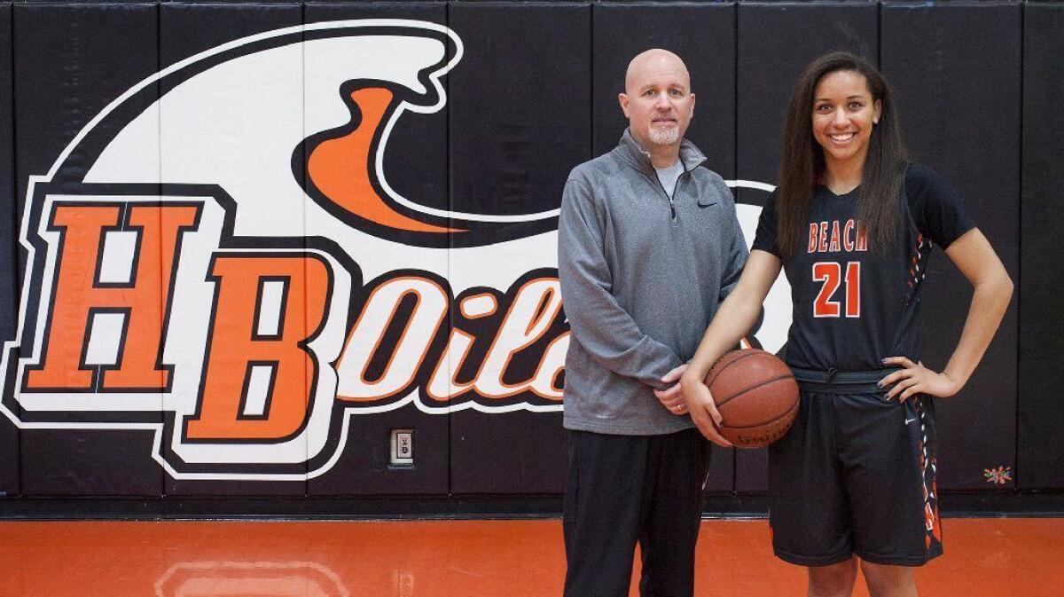 Huntington Beach High coach Russell McClurg, seen here with former standout Frankie Wade-Sanchez on April 12, 2017, is four wins away from 400 in his career.