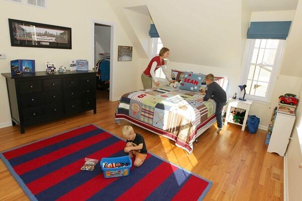 Caitlin Denker with her sons Ian, 3, and Sean, 6, in Sean’s new bedroom. A garage addition has added more space as well as peace of mind for the family.