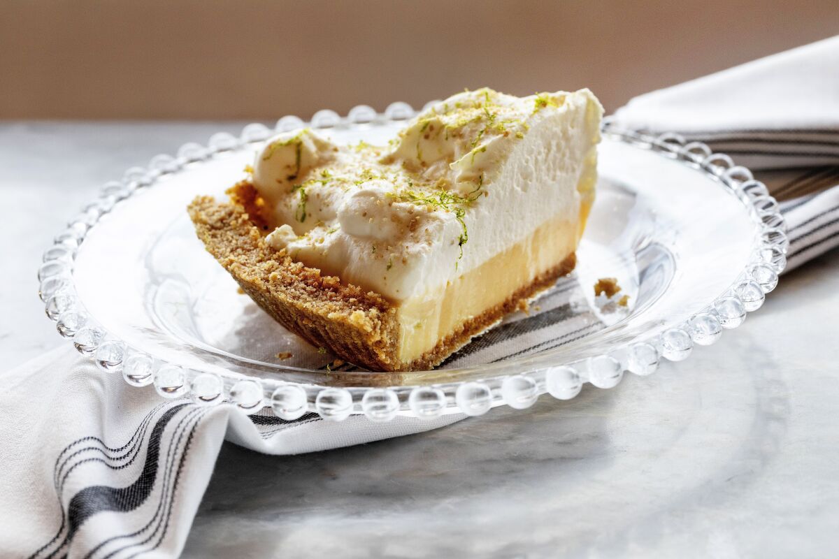 A slice of Key lime pie sits on a dish.