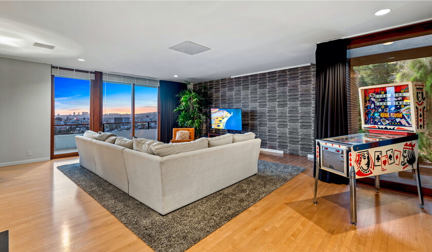 The hillside home includes three levels of decks, balconies and patios, as well as a swimming pool and spa.