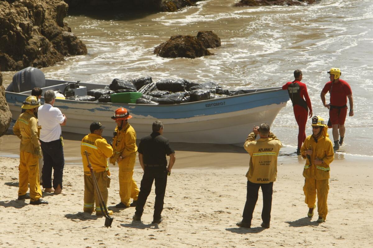 A panga-style boat loaded with as much as a ton of marijuana was seized after it washed ashore at Leo Carrillo State Beach in Malibu early Monday.