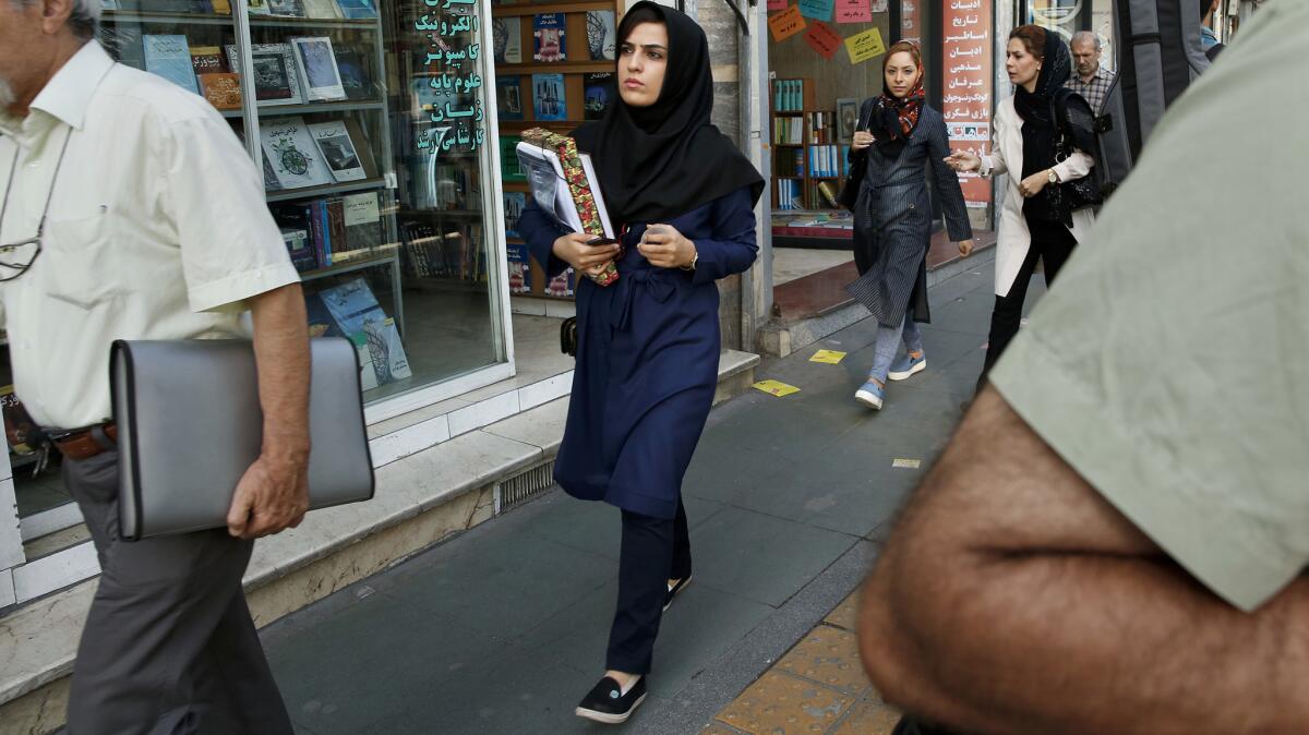 A woman shops for textbooks in downtown Tehran. More than 60% of university students in Iran are female, according to official statistics.