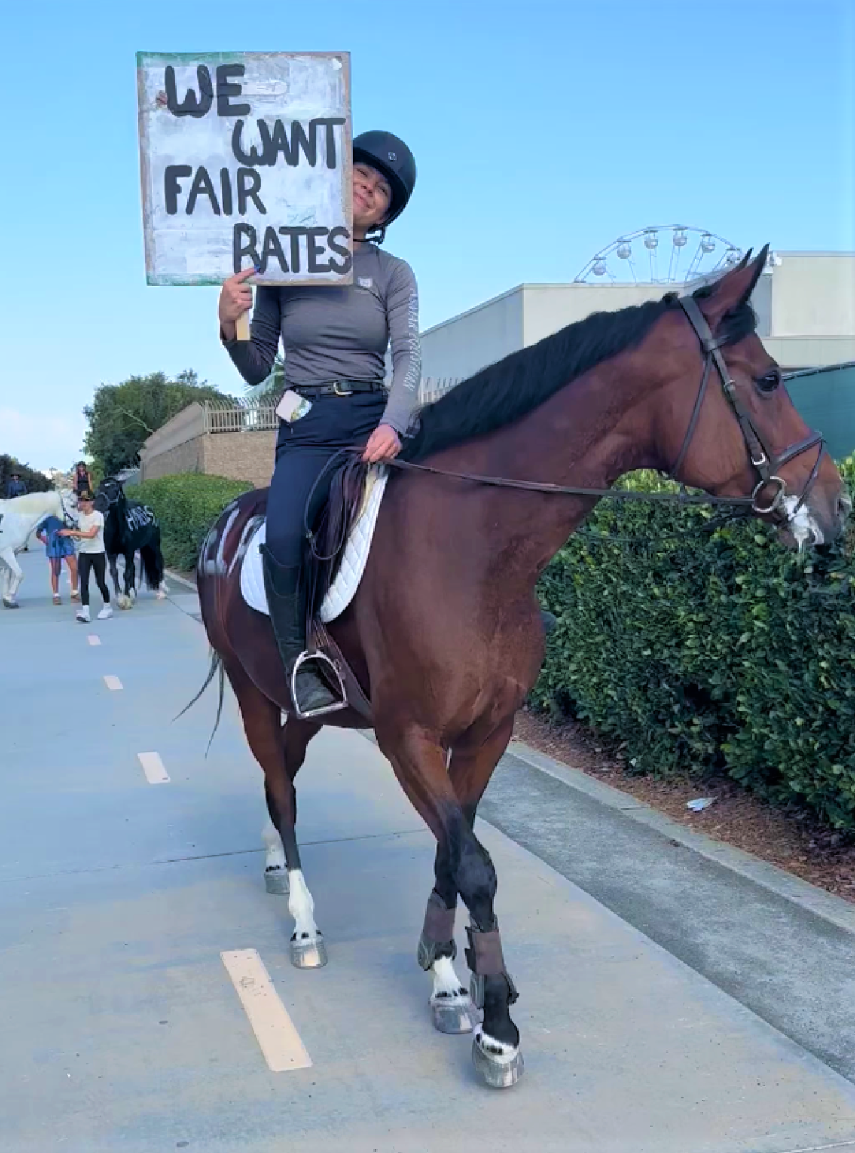 A rider protests outside the O.C. fairgrounds in Costa Mesa Thursday, August 1, 2024.