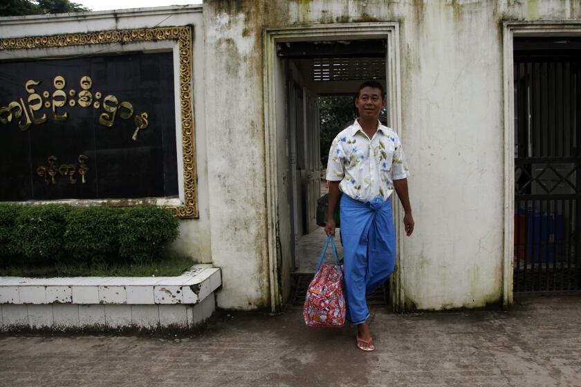 Newly released political prisoner Win Hla leaves Insein Prison in Myanmar on Tuesday after receiving amnesty from President Thein Sein.