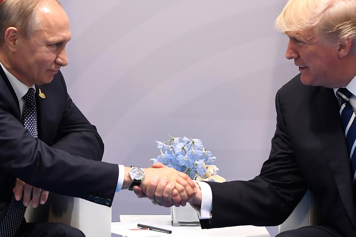 President Trump and Russia's President Vladimir Putin shake hands during a meeting on the sidelines of the G20 Summit in Hamburg, Germany, on July 7, 2017.