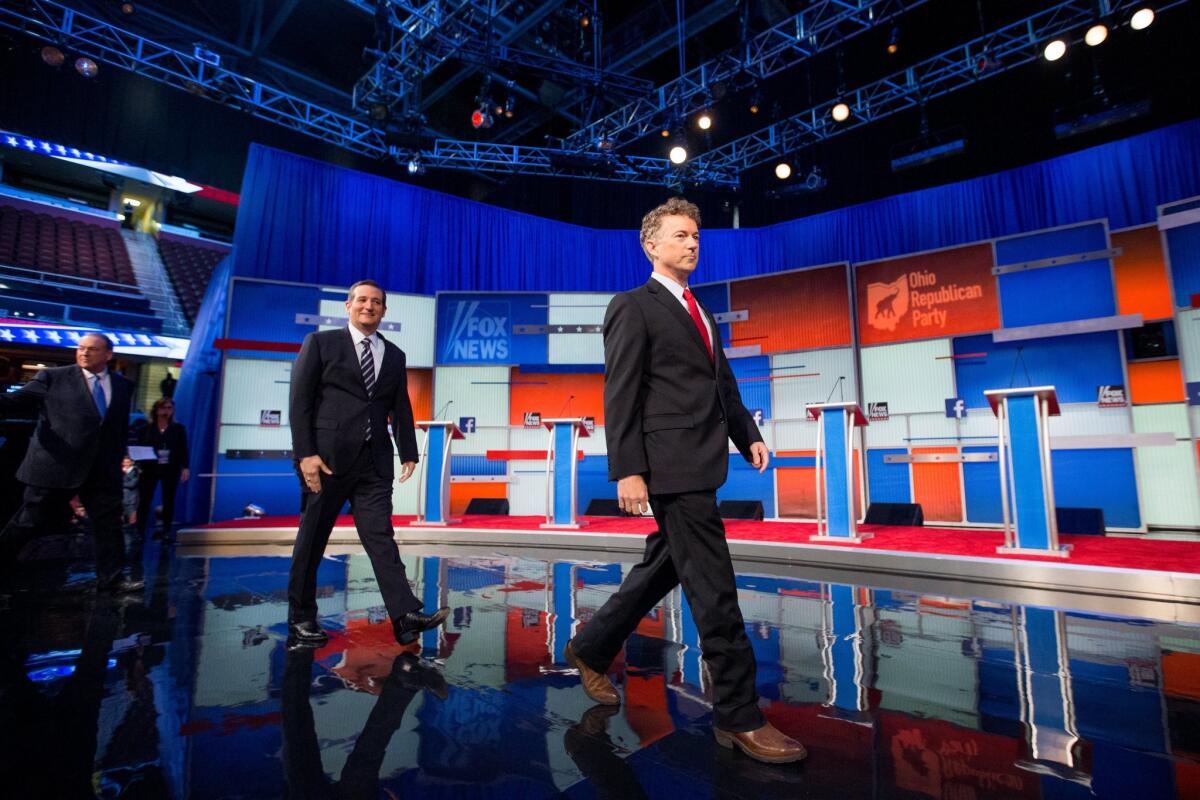 GOP presidential candidates, from left, former Arkansas Gov. Mike Huckabee, Sen. Ted Cruz, R-Texas, and Sen. Rand Paul, R-Ky., take the stage for the first Republican presidential debate on Aug. 6. Their defense of Kentucky clerk Kim Davis over her refusal to obey a court order raises questions about the choices they'd make as president.