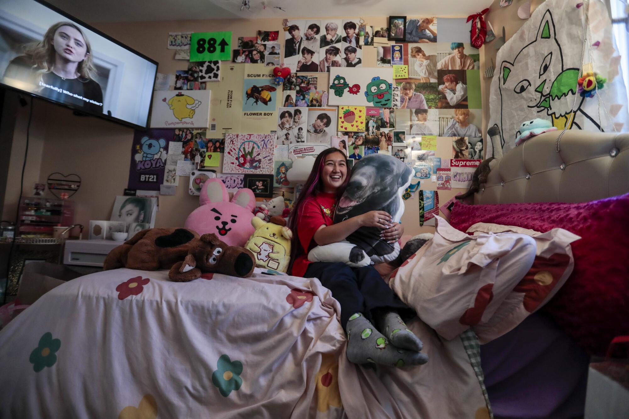 Jade Magallanes embraces a pillow featuring a photo of her dog Buddy, who died two years ago.