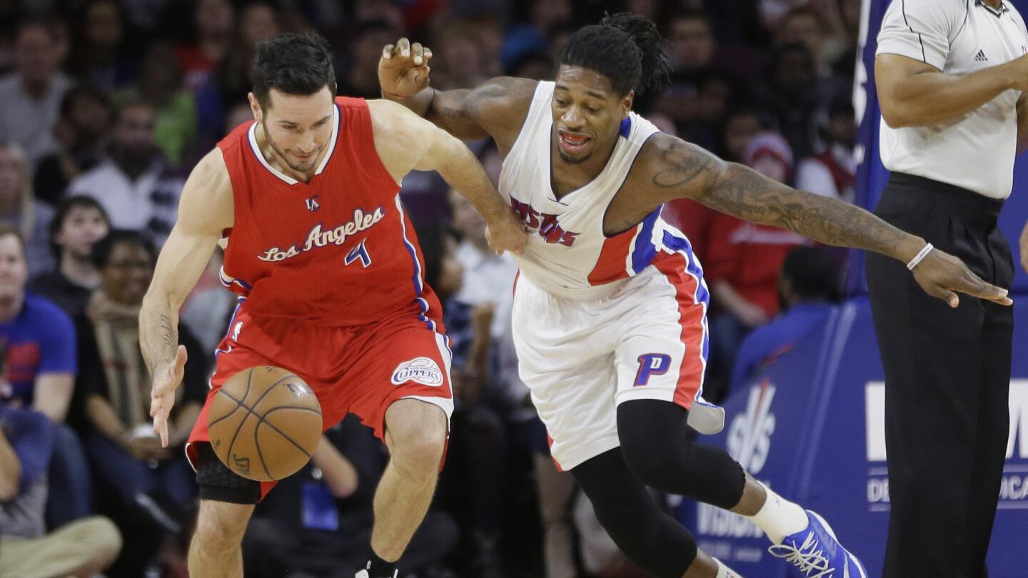 Clippers guard J.J. Redick, left, and Detroit Pistons forward Cartier Martin chase after a loose ball during the first half of Wednesday's game.