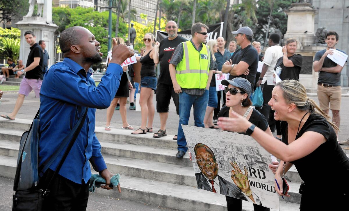 Supporters and detractors argue over President Jacob Zuma in Durban, South Africa, in February.