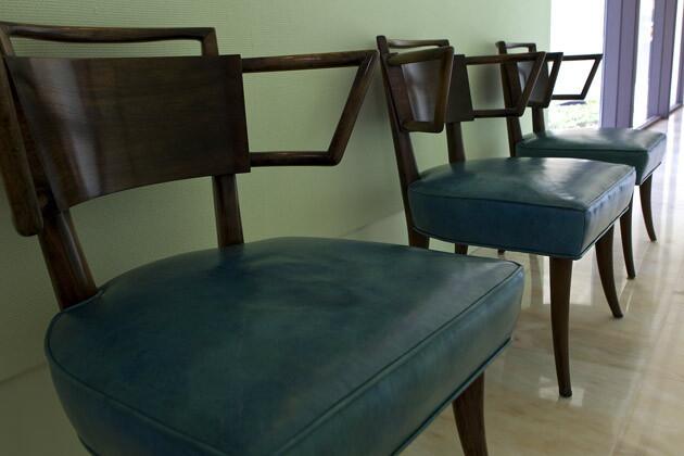 More Regency chic: walnut chairs upholstered in turquoise leather.