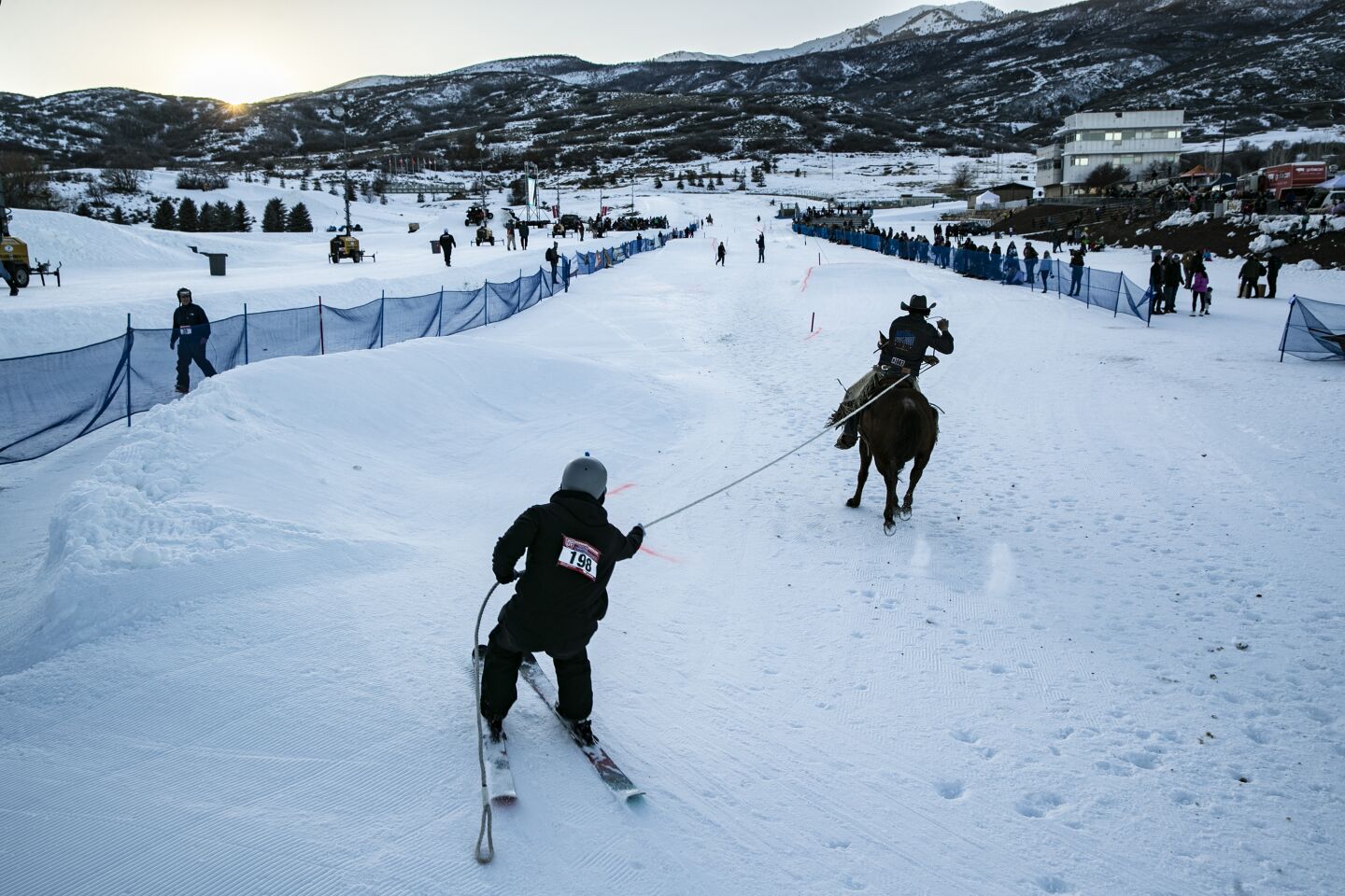 Joe Fellar is pulled by Bumper, ridden by Clayson Hutchings, in the Novice Division of Skijoring Utah.