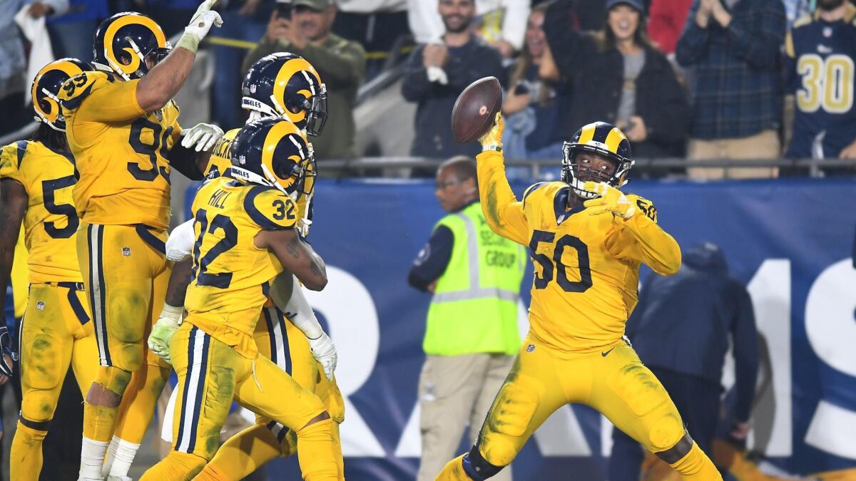 Rams linebacker Samson Ebukam spikes the ball after returning an interception for a touchdown Nov. 19 against Kansas City.