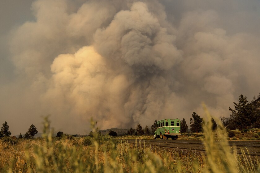 Smoke from the Lava Fire billows over Highway 97 in Weed, Calif., on Thursday, July 1, 2021. Firefighters are battling multiple fires in the region following high temperatures and lightning strikes. (AP Photo/Noah Berger)