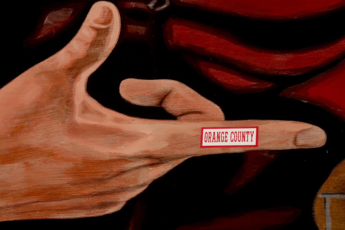 Someone added "Orange County" to the forefinger of a gigantic wood-paneled image of actor James Dean.