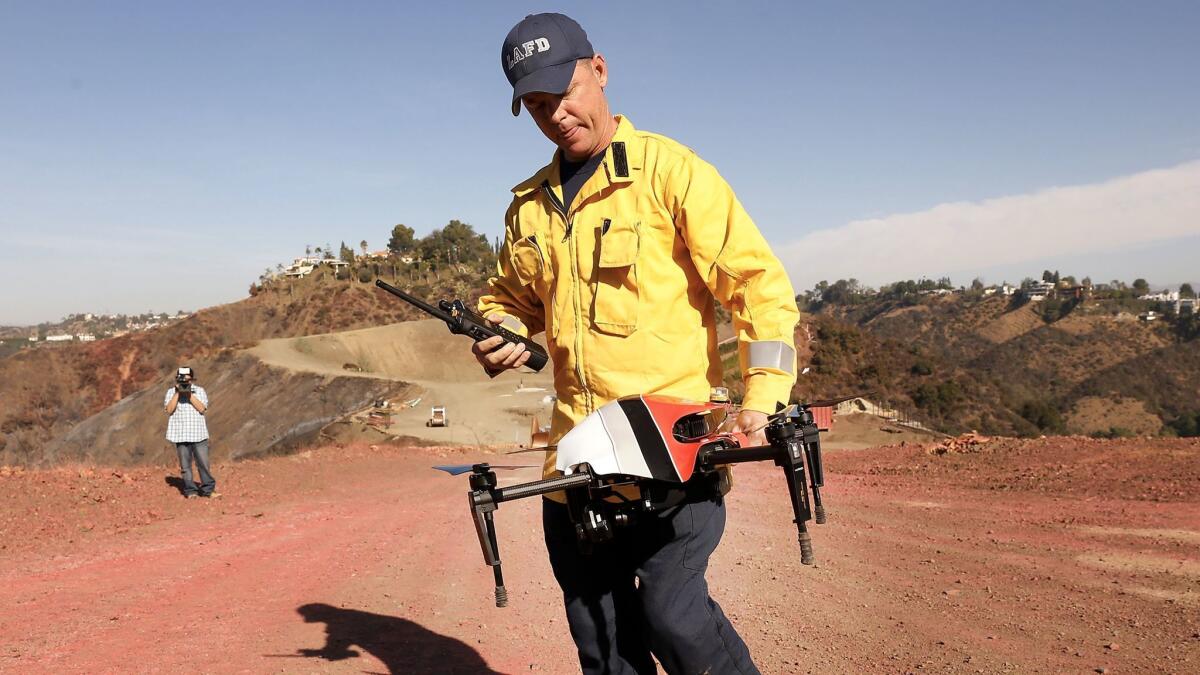 LAFD firefighter David Danielson, recovers the drone.