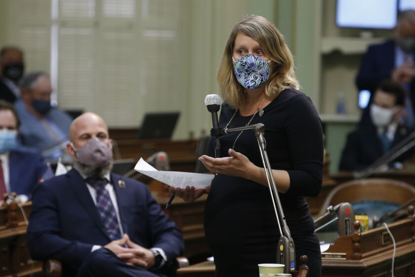 Assemblywoman Buffy Wicks, D-Oakland, wears face mask as she calls on lawmakers to approve a measure to place a proposed constitutional amendment on the ballot to allow state legislators to vote remotely during emergencies, at the Capitol in Sacramento, Calif., on Wednesday, June 10, 2020. Wicks said she attended the session, even though she is pregnant, to ensure her constituents weren't disenfranchised. The Assembly approved the measure and it sent it to the Senate which has until June 25 to pass the proposal and place it before voters in November. (AP Photo/Rich Pedroncelli)