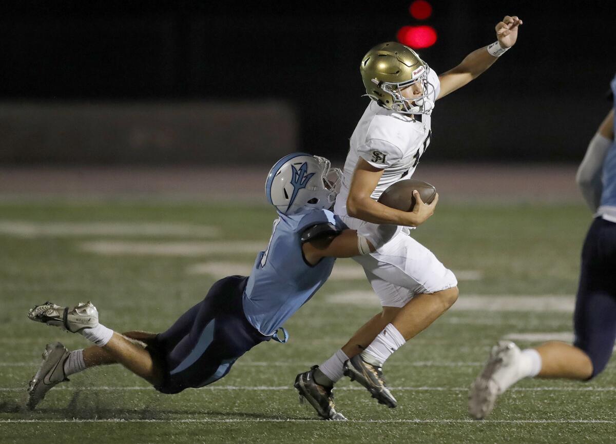 San Juan Hills quarterback Michael Tollefson can't escape the sack of Corona del Mar middle linebacker Christian Brooks.