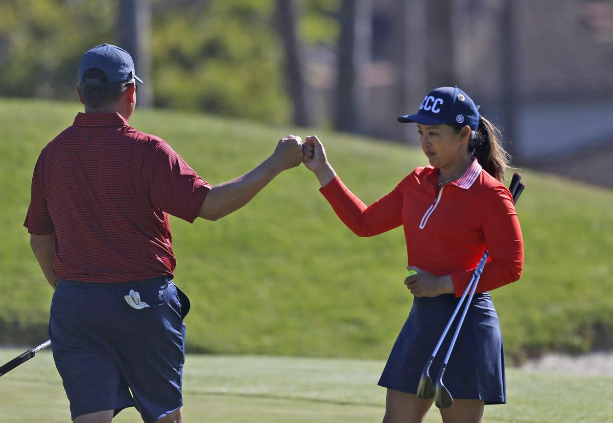 Robert Pang and Erika Ilagan celebrate a birdie during the 24th annual Jones Cup golf tournament on Wednesday.