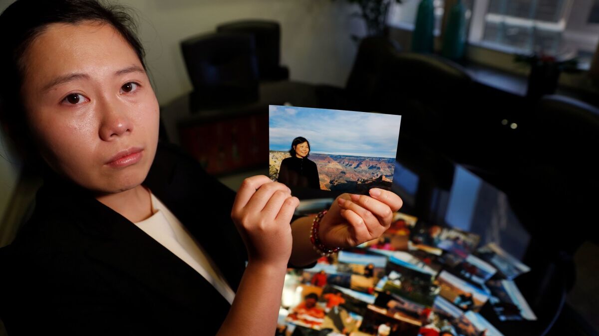 Yijing Chen holds a photo of her mother, Hongfen Shen, 53, who died in 2016 while crossing the street in Calabasas.