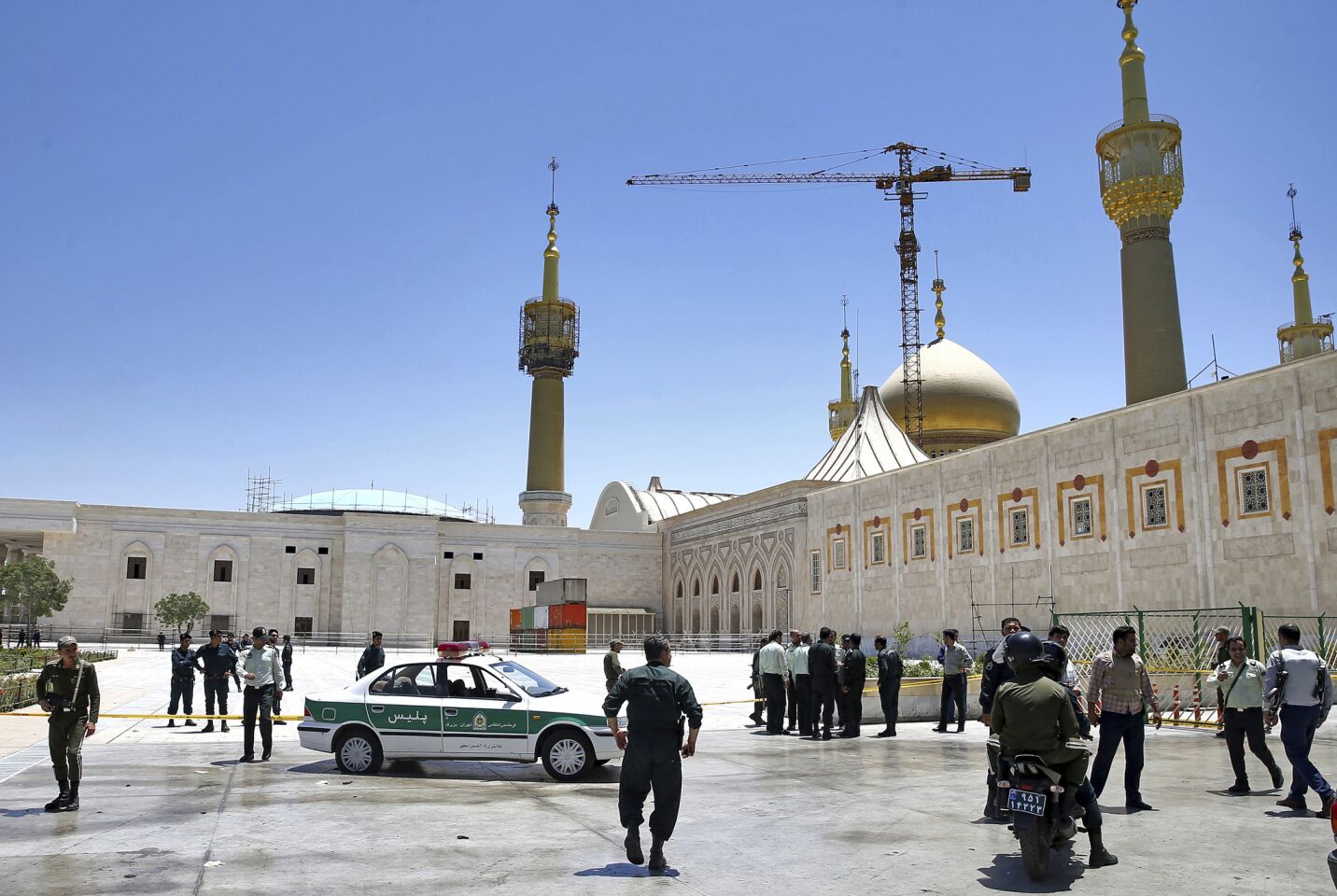 Police monitor the scene around the shrine of late Iranian revolutionary founder Ayatollah Khomeini after an assault by several attackers in Tehran.