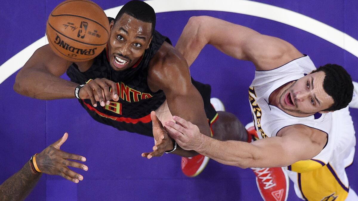 Hawks center Dwight Howard, left, and LLakers forward Larry Nance Jr. battle for a rebound during the first half Sunday.