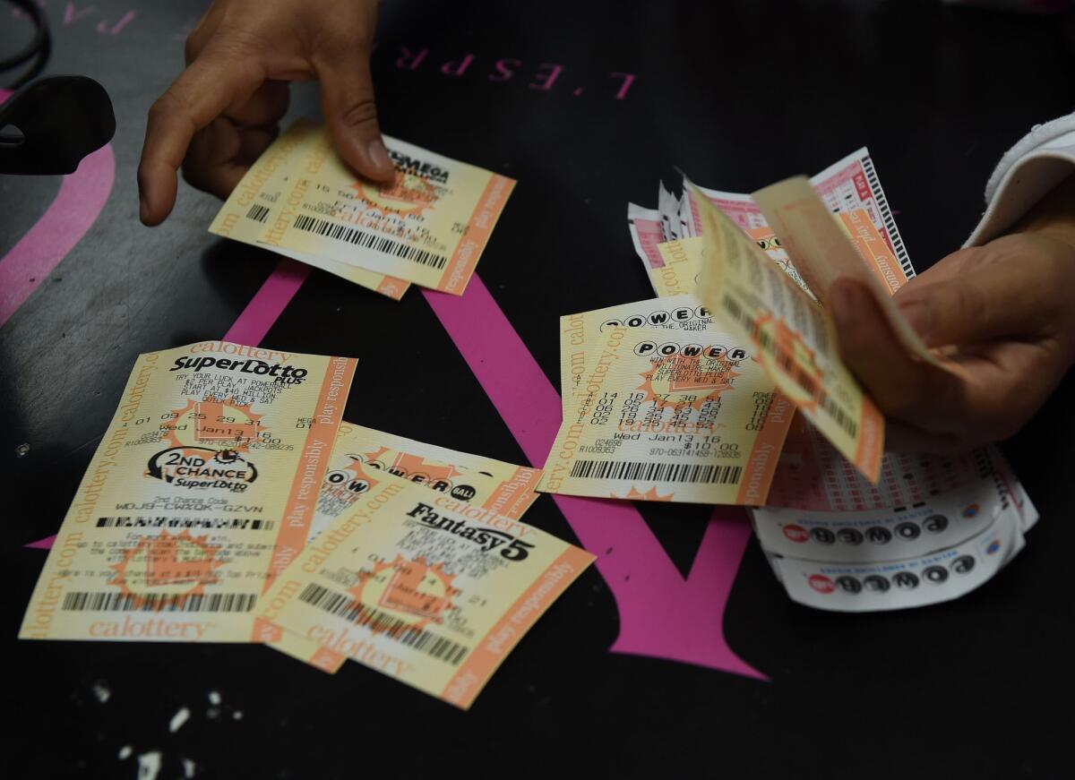 A customer picks up her California Powerball lottery tickets at the famous Bluebird Liquor store in Hawthorne in 2016.