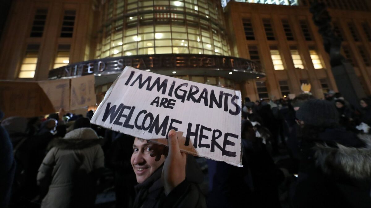 People gather outside of the U.S. District Court in New York, where a judge issued an emergency stay for those detained at airports, on January 28.