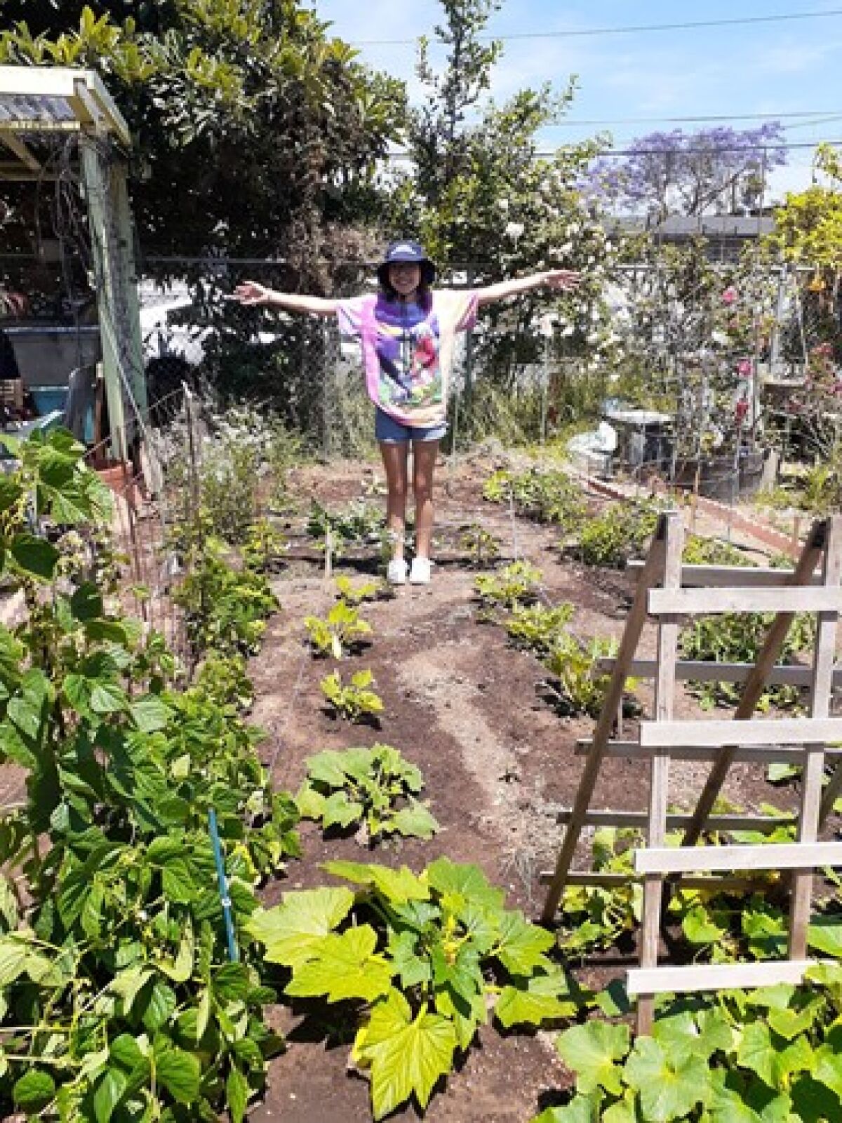Point Loma High School senior Fania Villarreal stands in her plot at the Ocean Beach Community Garden.
