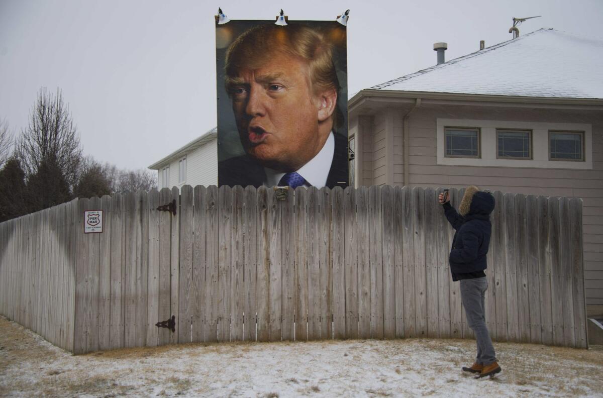 A giant poster of Republican presidential candidate Donald Trump stands on display in the backyard of a supporter's residence in West Des Moines, Iowa on Jan. 25.