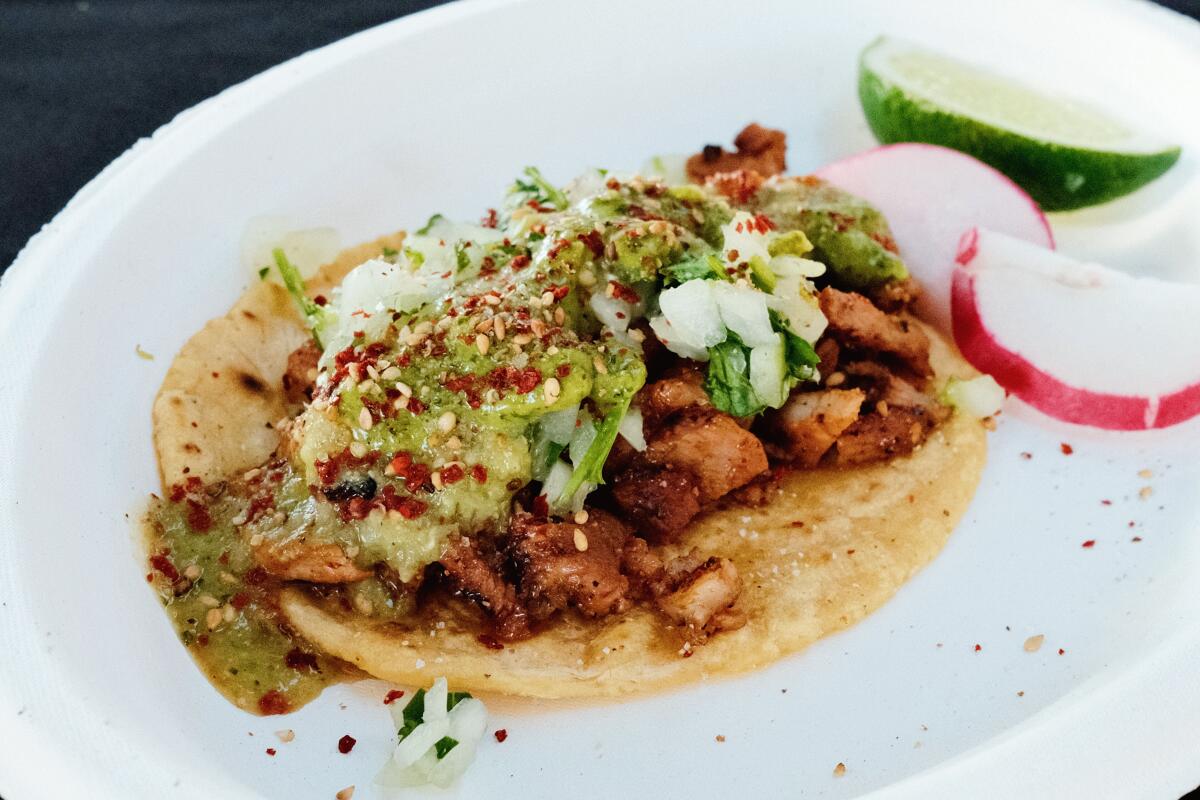 An al pastor taco at Tacos por Vida, served with radish and lime slices