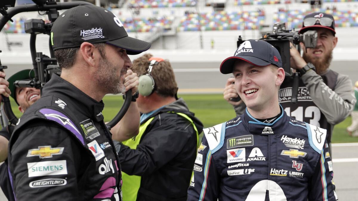 William Byron, right, is congratulated by Jimmie Johnson, left, after winning the pole position Sunday for the Daytona 500.