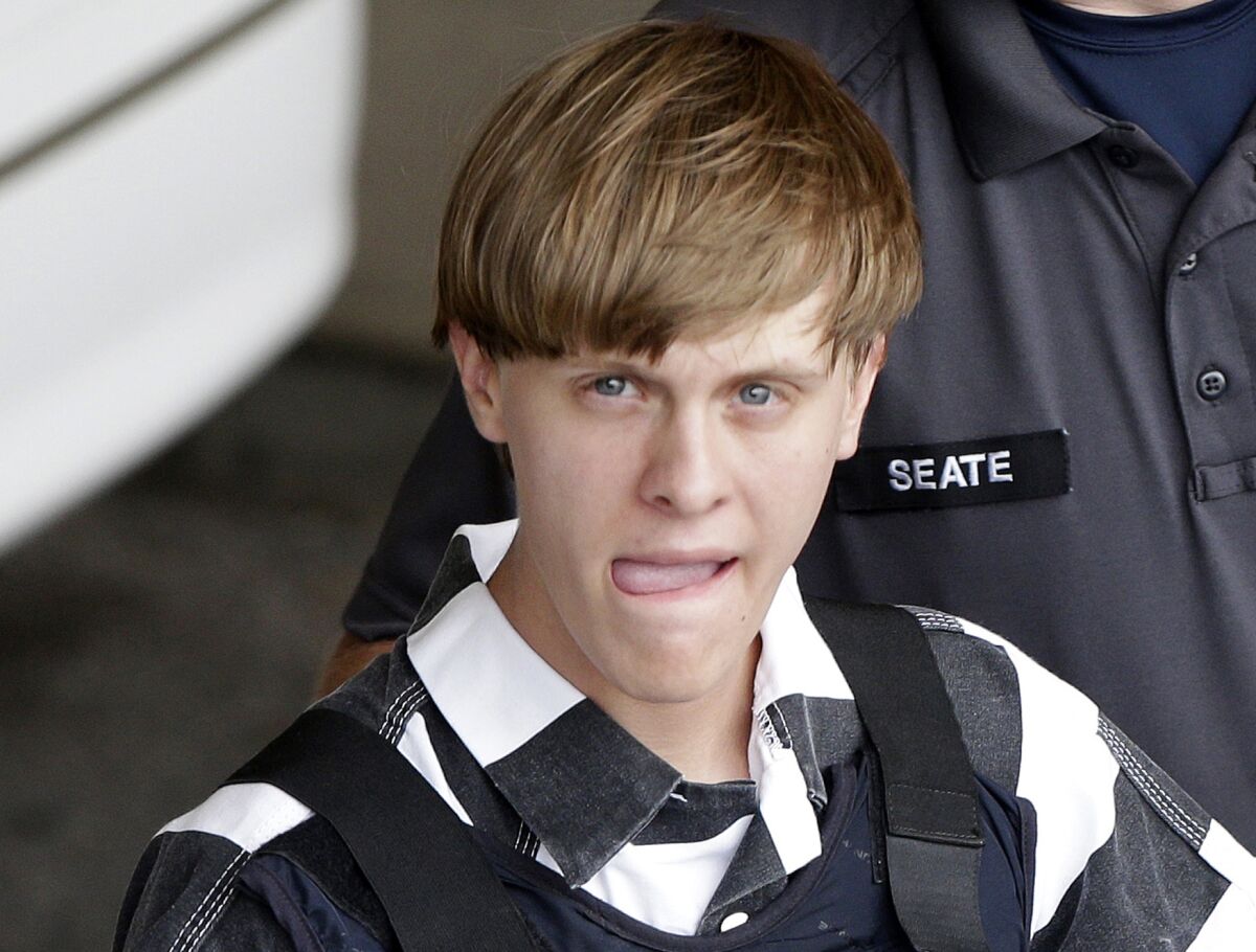 FILE - In this June 18, 2015, file photo, Charleston, S.C., shooting suspect Dylann Storm Roof is escorted from the Cleveland County Courthouse in Shelby, N.C. Attorneys for the convicted Charleston church shooter have asked the U.S. Supreme Court to decide how to handle disagreements over mental illness-related evidence between capital defendants and their attorneys. (AP Photo/Chuck Burton, File)