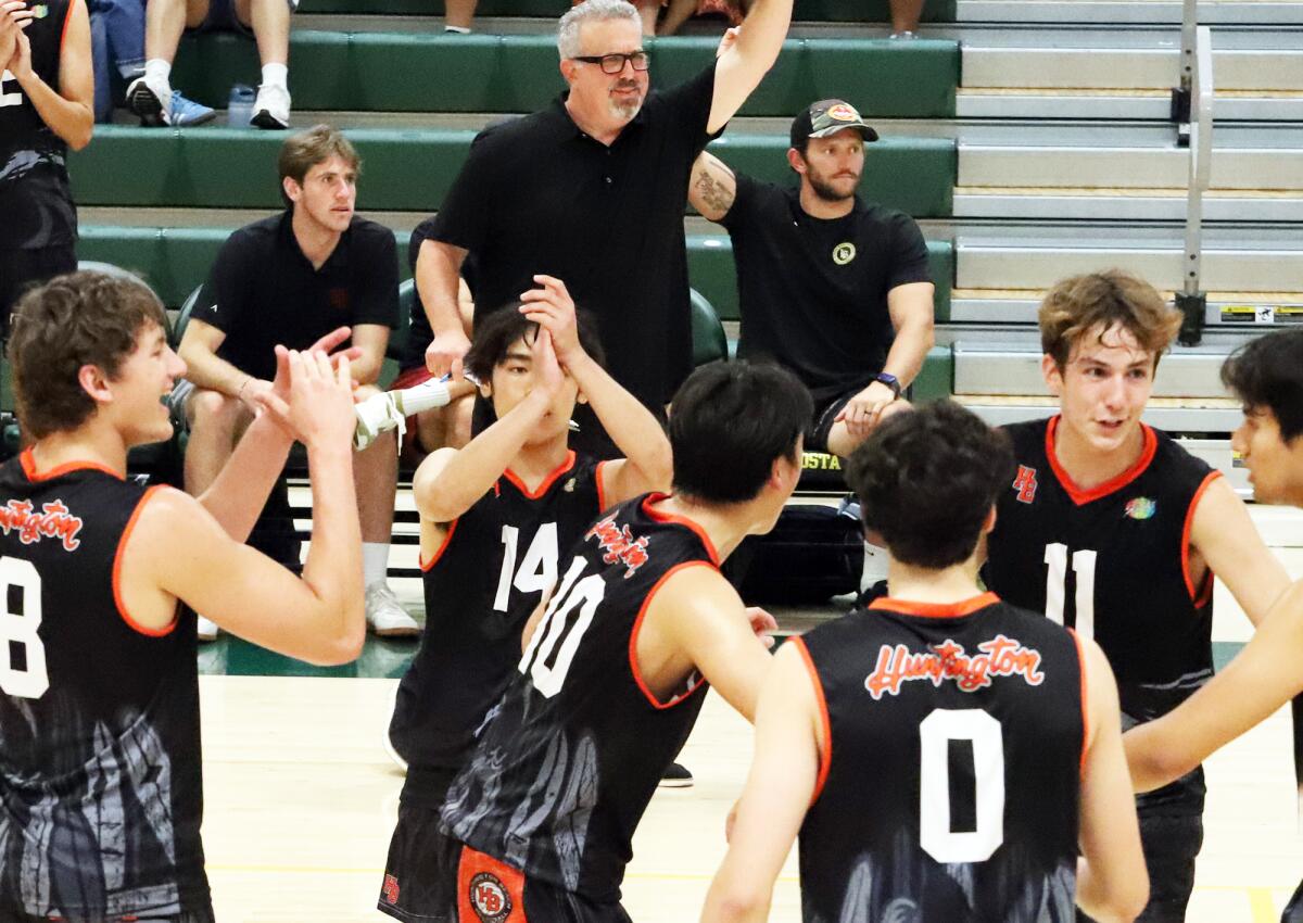 The Huntington Beach boys' volleyball team celebrates a point against Mira Costa on Saturday.