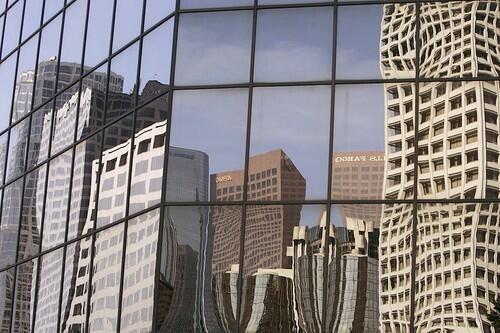 ACROSS THE WAY: Skyscrapers in L.A.s downtown, east of the Harbor Freeway, are reflected in the mirrored windows of a self-storage building on 6th Street in the City West area.
