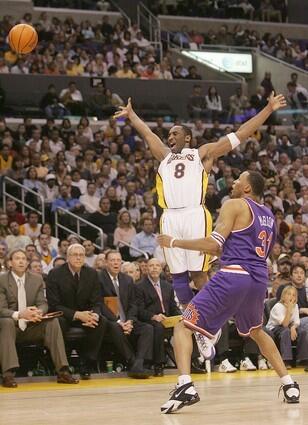Kobe Bryant tries to get the referee's attention after being fouled by Phoenix Suns' Shawn Marion.