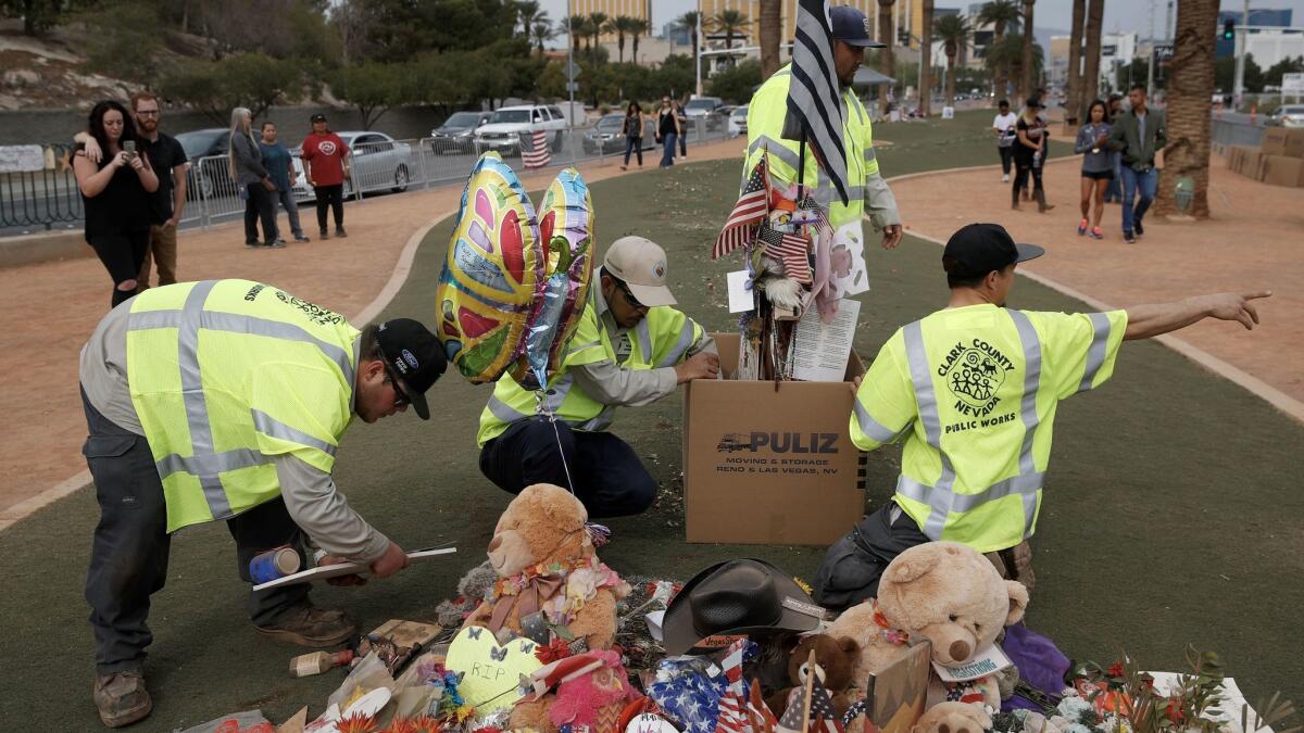 Workers remove a makeshift memorial honoring the victims of the Oct. 1 mass shooting in Las Vegas.