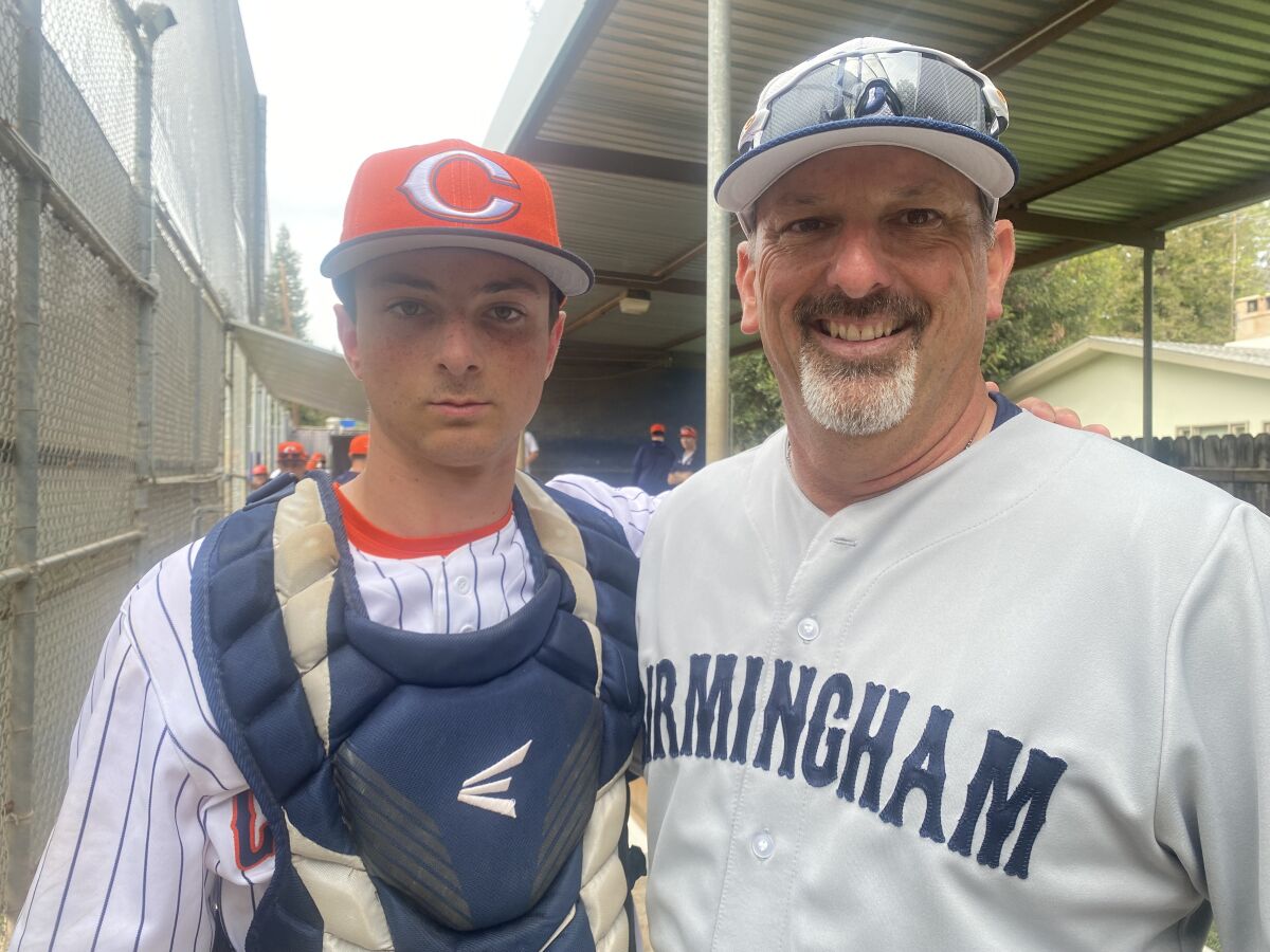 Birmingham High coach Matt Mowry, right, and his son Nolan, a catcher for Chaminade.