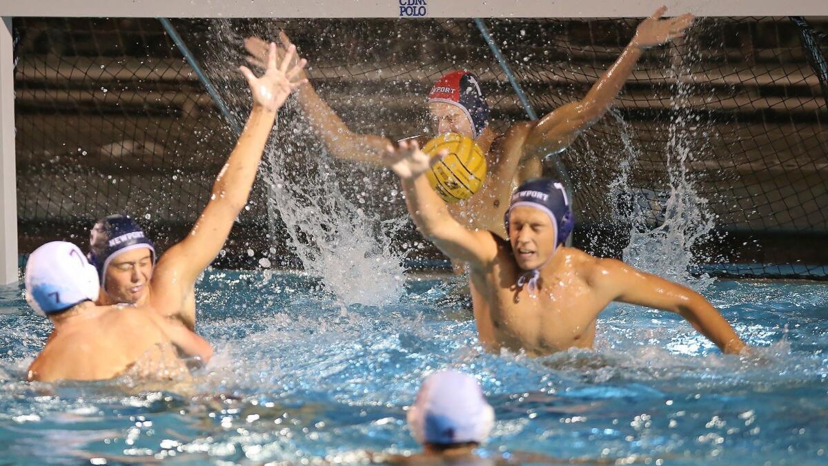 Newport Harbor High goalkeeper Blake Jackson makes a point-blank stop against Laguna Beach in a Surf League match at Corona del Mar High on Wednesday.