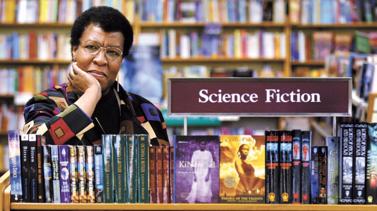 Octavia Butler is pictured in 2004 near some of her novels at a store in Seattle. (Joshua Trujillo / Associated Press)