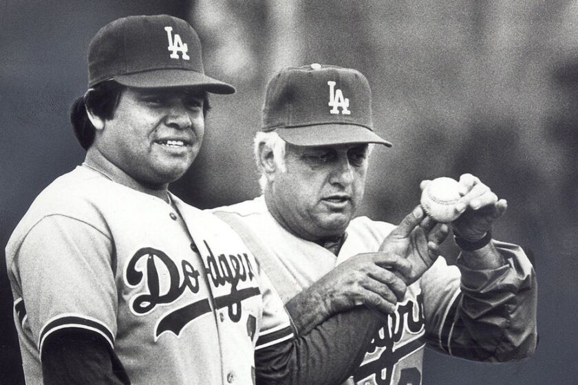 Dodgers manager Tommy Lasorda check the grip of pitcher Fernando Valenzuela during a spring training workout in 1983.