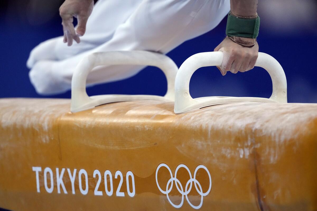FILE - In this Aug. 1, 2021, file photo, David Belyavskiy, of the Russian Olympic Committee, performs on the pommel horse during the artistic gymnastics men's apparatus final at the 2020 Summer Olympics in Tokyo, Japan. At the Games, men swing around a leather-covered block with handles called a pommel horse, that in early iterations roughly mimicked the size and shape of the actual animal. (AP Photo/Ashley Landis, File)