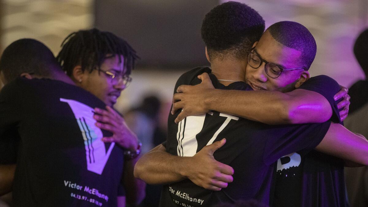 Easweh Harrison, 23, right, embraces a fellow member of Brothers Breaking BREAD, a student organization founded by black men at USC, during a memorial for slain USC Thornton School of Music student Victor McElhaney at the Ronald Tutor Campus Center Ballroom on campus.