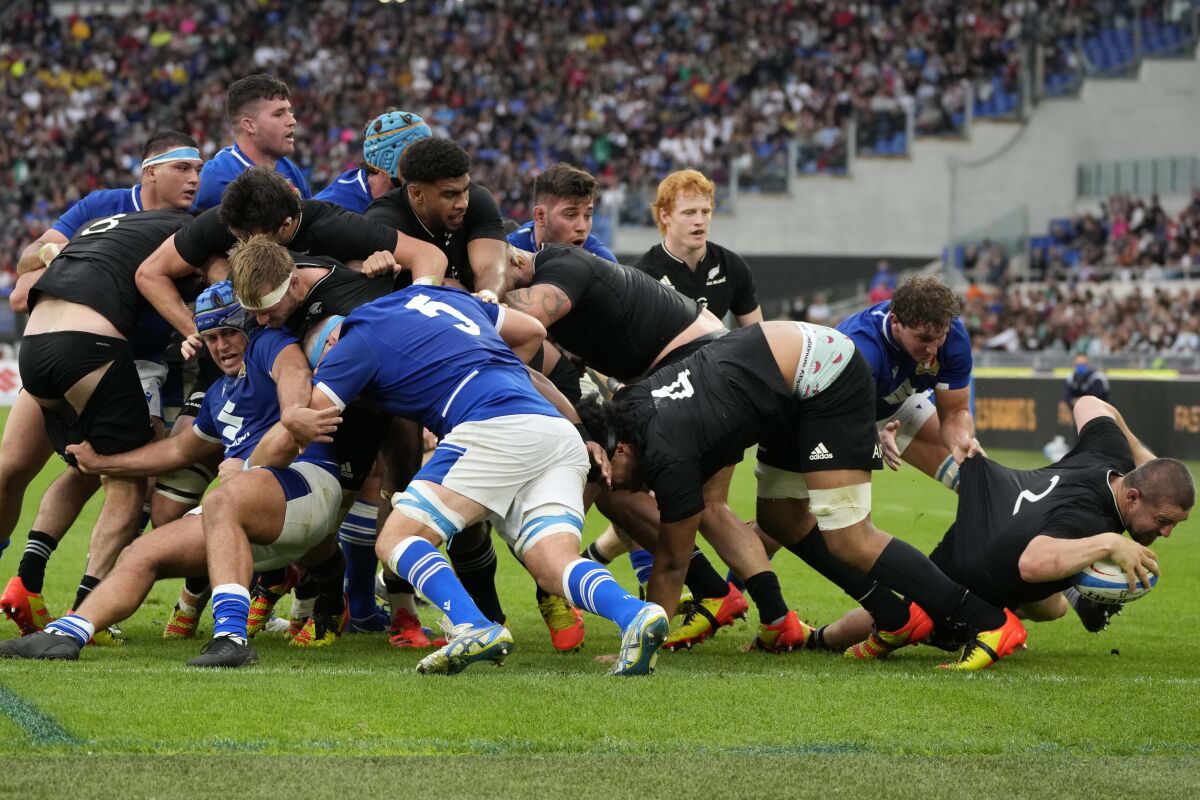 New Zealand's Dane Coles, right, scores a try during a rugby union international match between Italy and All Blacks New Zealand at Rome's Olympic Stadium, Saturday, Nov. 6, 2021. (AP Photo/Alessandra Tarantino)