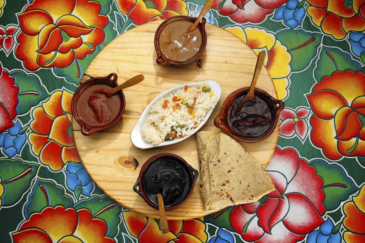 Oaxacan moles at Guelagetza can be sampled on a Festival de Moles plate of coloradito, mole negro, mole rojo and estofado.