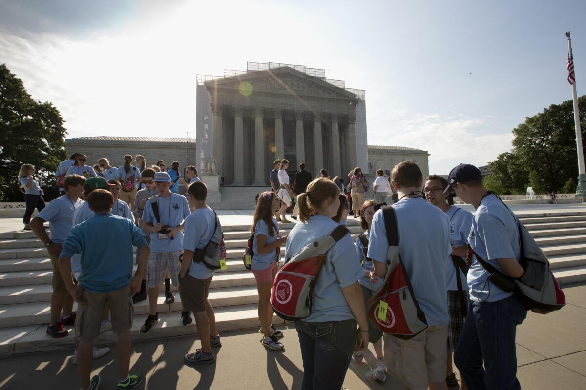 Visitors wait outside of the Supreme Court in anticipation of key decisions.