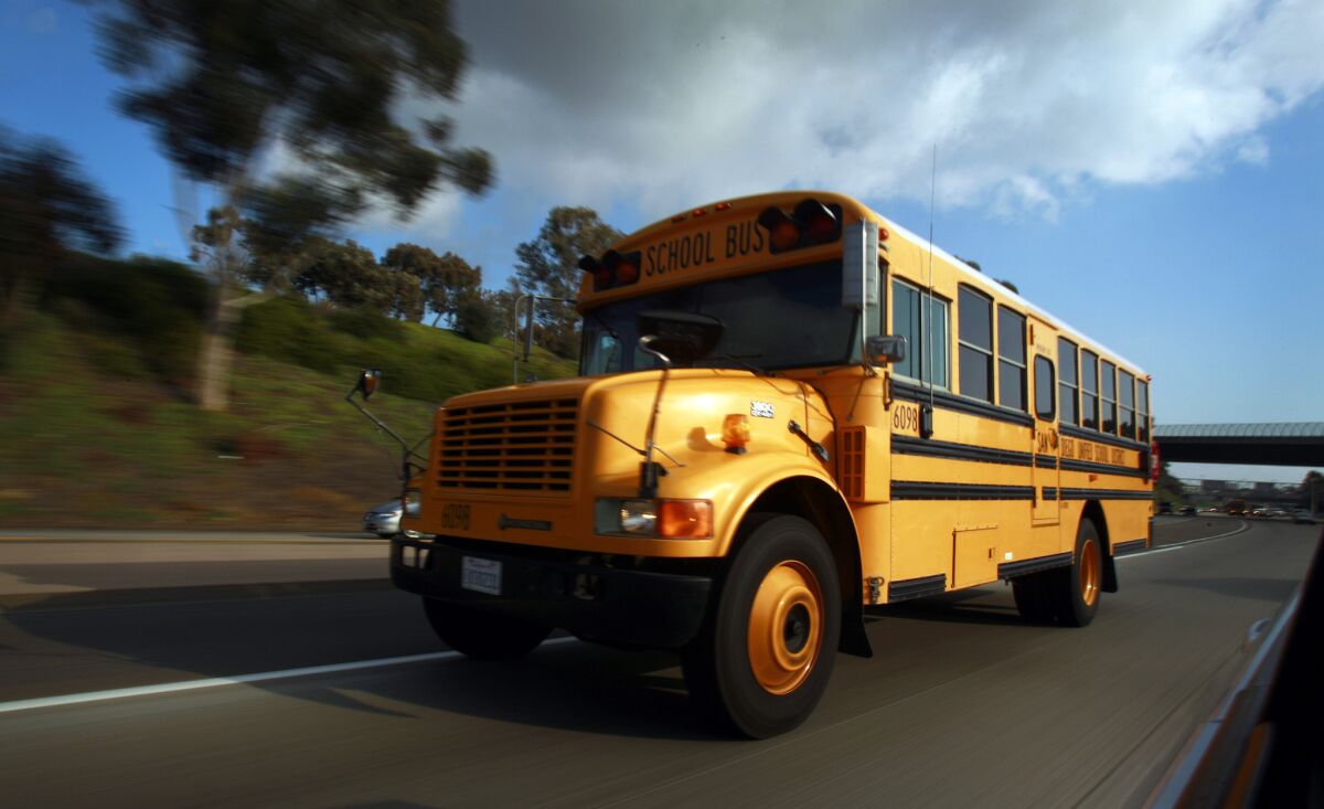 A San Diego Unified School bus drives on I-805 after picking up students after school on Wednesday, Dec. 14, 2011.