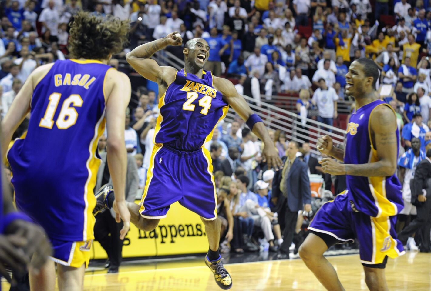 Kobe Bryant jumps for joy as Pau Gasol, left, and Trevor Ariza approach after the Lakers won the 2009 title.